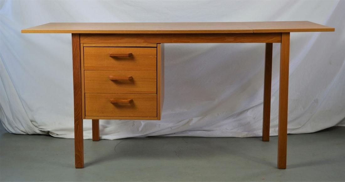 DANISH MID CENTURY MODERN DROP LEAF TEAK DESK: Danish modern drop leaf teak desk in the manner of Arne Vodder. Desk is C. 1960's/70's Labelled: Copenhagen Denmark Interform Collections A/S Measures: H- 28 1/4" W (without drop leaf extension) - 46"