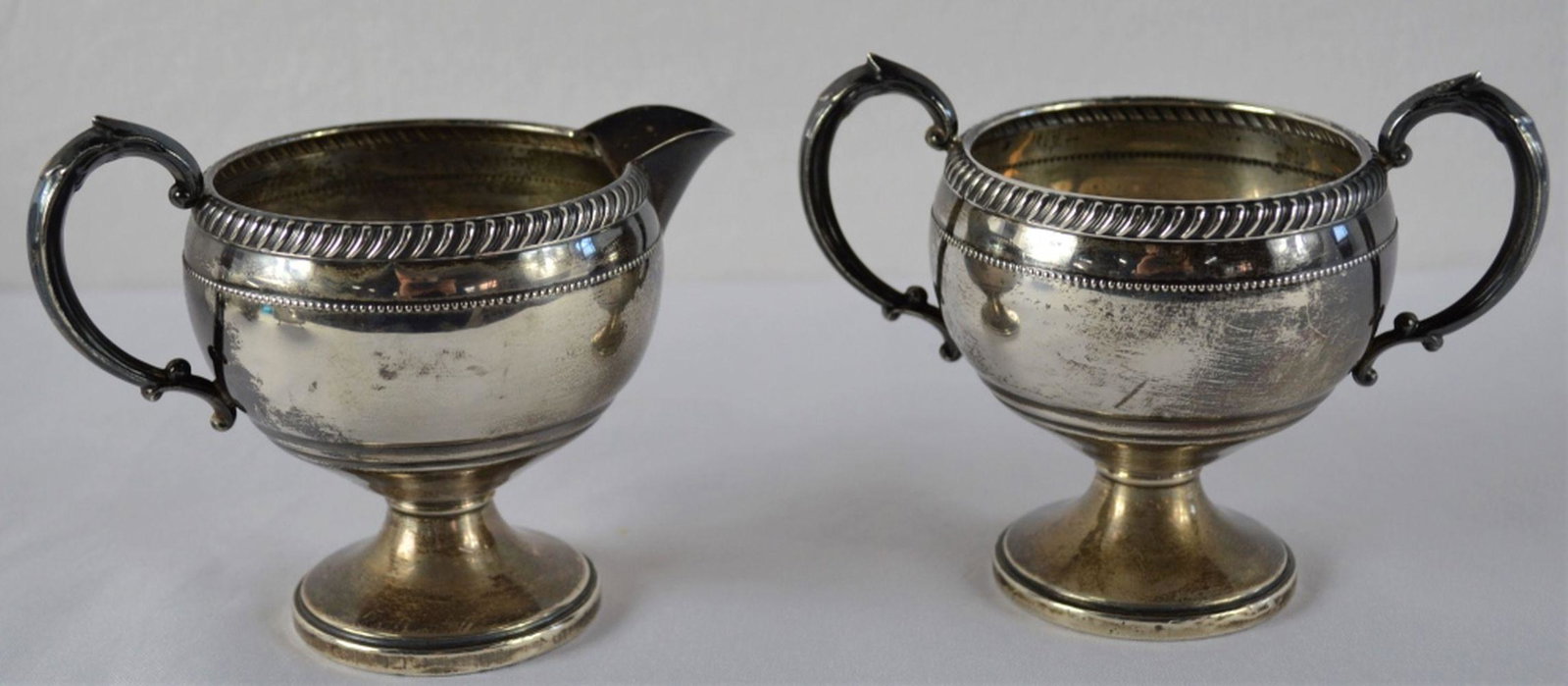 STERLING SILVER CREAM & SUGAR SET HALLMARKED: A sterling silver (weighted) cream and sugar set. Sugar is 2 handled. Both marked on the base. Measures: 2 7/8" to rim. Gross Weight: 206 grams Gross Weight: 206 grams