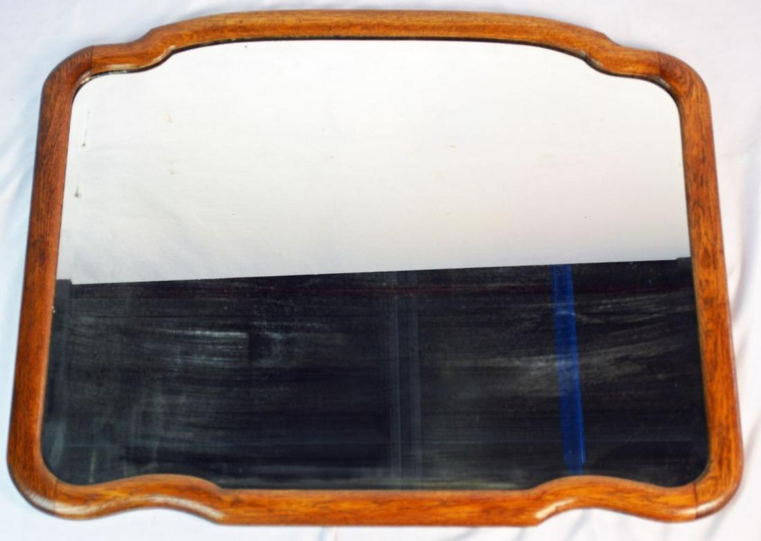 ANTIQUE MISSION STYLE OAK FRAME MIRROR: Antique oak frame mission era beveled edge mirror. Tag, verso, "The Manchester Furniture Company". Measures: 24 1/2" x 30 1/2"