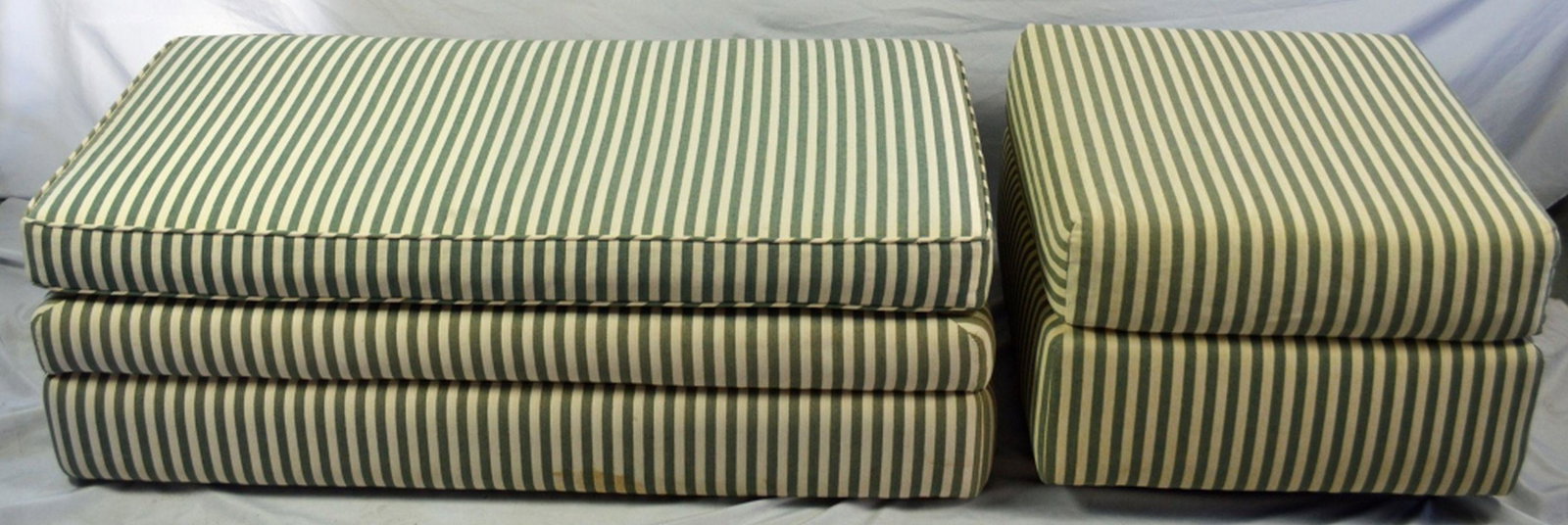 LOT 2 OTTOMAN / UPHOLSTERED BENCH BEACH LOOK: Modern striped upholstered ottoman (on casters) and a bench that could double as a ottoman (top cushion detachable). No label attached, appears to be custom. Measures: Ottoman: H: 17'' X L: 24'' X W: 