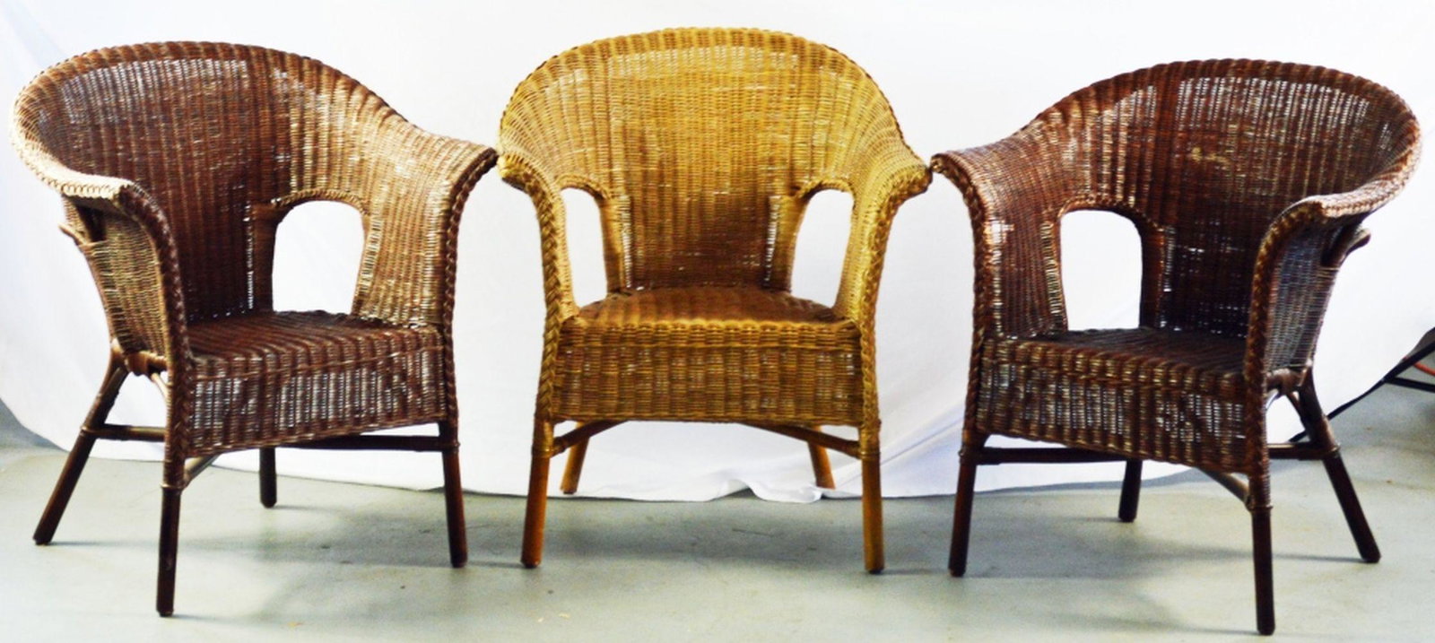 3 VINTAGE WOVEN WICKER CHAIRS: Lot of 3 vintage wicker arm chairs. The chairs are well made, clean, and were used in an indoor setting. H: 32" x 28.5"