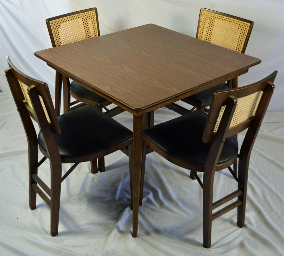 STAKMORE MCM DINING / CARD TABLE & 4 CHAIR SET: Mid century modern Stakmore (labels attached) folding table and chair set. The set consists of a table and 4 cane back folding chairs. A perfect poker or bridge table, or dining set for tight spaces.
