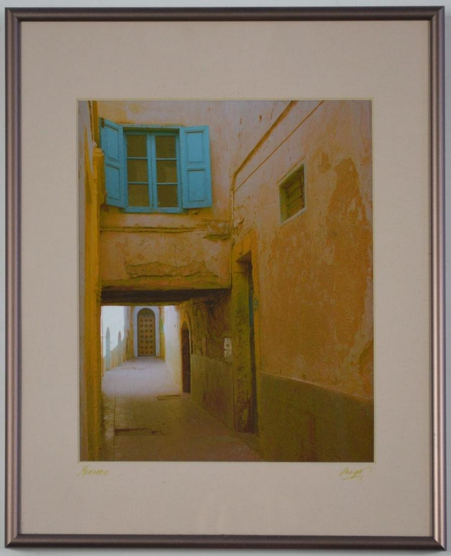 ART PHOTOGRAPH MOROCCO SIGNED: An signed photograph of a street in Morocco. The work is signed, on the matting, and is titled: "Morocco". There is an artist label (Mary Ann G. Neuman) and date (2001), verso. Framed, under glass. Me
