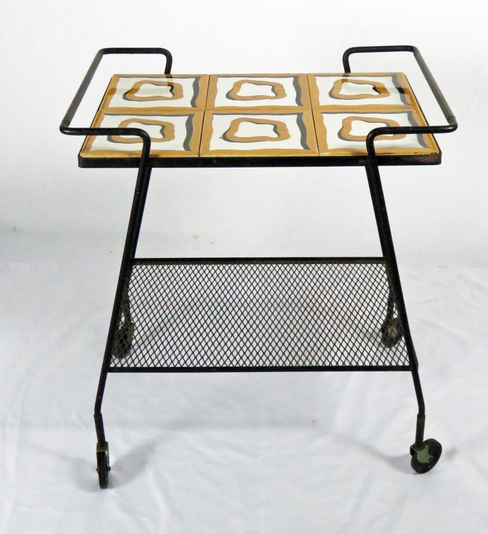 MID CENTURY MODERN TILE TOP SERVING / BAR CART: Unusual mid century modern indoor/outdoor funky design tile top metal serving cart. Two levels and casters with a 60's feel top design. Reminiscent of a Bertoia piece. Measures: 26" x 17 1/4" Top x 30