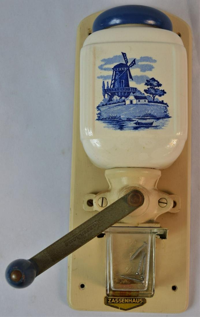 ZASSENHAUS ANTIQUE DELFT BLUE COFFEE GRINDER: Vintage Zassenhaus Delft porcelain style coffee grinder. Dutch style design applied to the top. Grinder is labelled and the crank has the impressed Zassenhaus mark. Marked as model #830. Measures: H 1