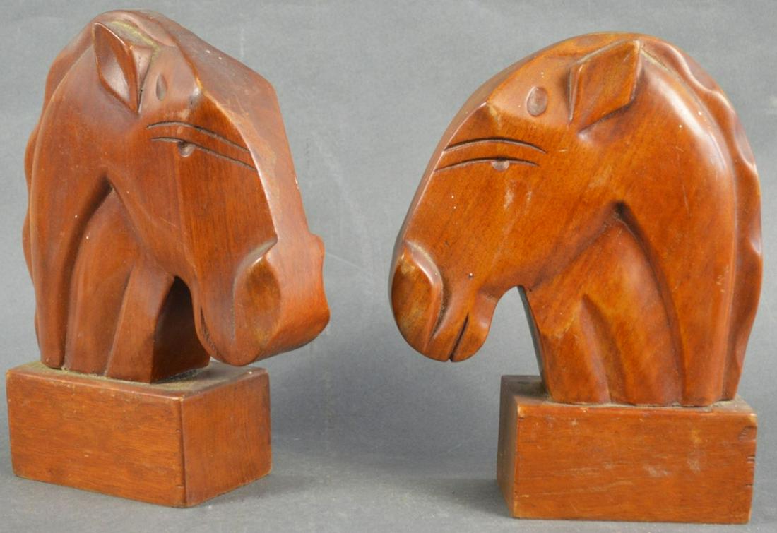 CARVED WOOD HORSE HEAD BOOKENDS MID CENTURY MODERN: A pair of mid century modern carved wooden horse head bookends. Unlabeled. Perfect for the equestrian in your life.... Measures: H 10 1/4" x W 3" x L 8"