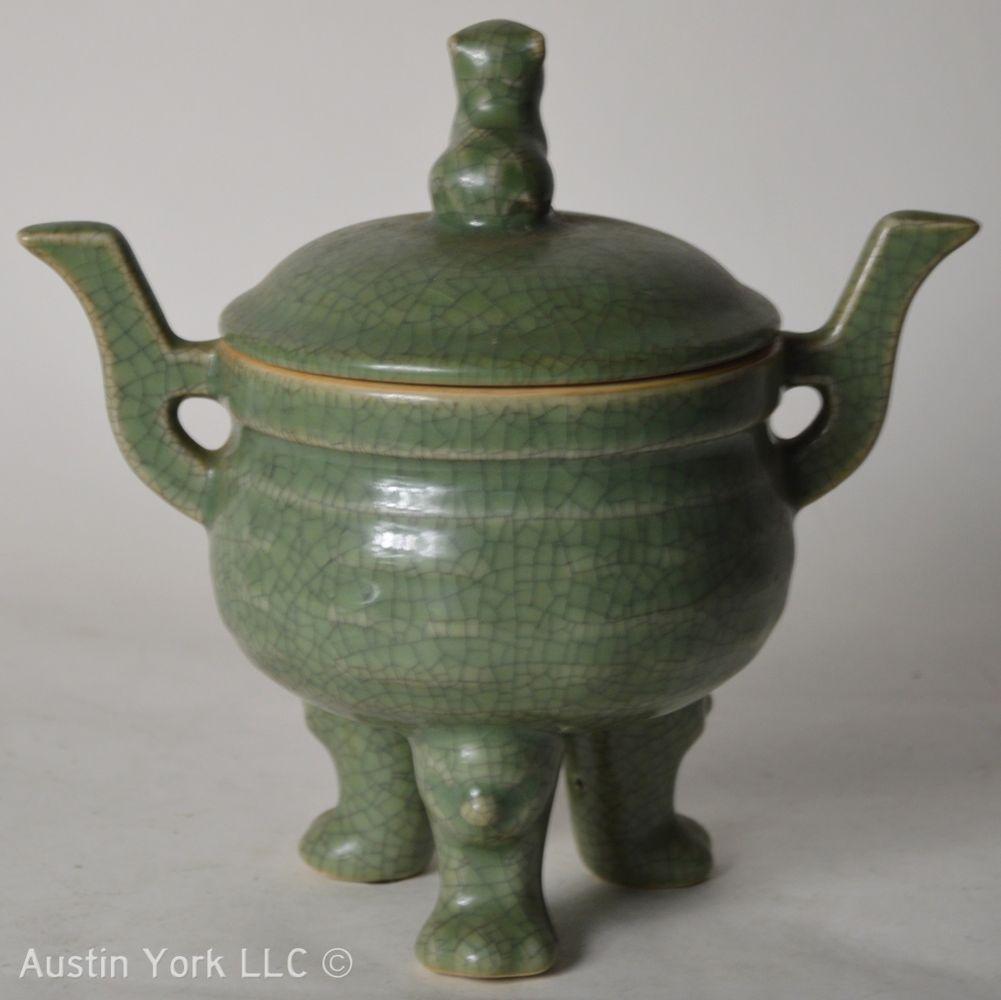 CHINESE ARCHAIC FORM DING: Chinese archaic form celadon crackle glazed porcelain covered Ding, 20th century. Measures: H 7 1/2" x W 7 1/2" x D 5"