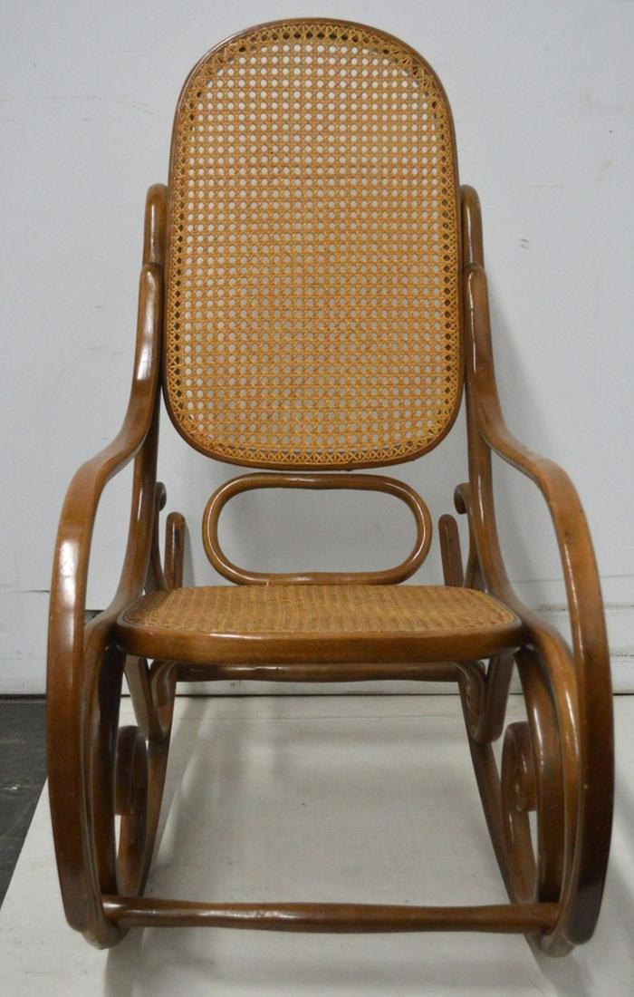 THONET BENT WOOD ROCKING CHAIR: A vintage Thonet (marked) bentwood and cane rocking chair. Measures: H 40" x W 20" x D 41"