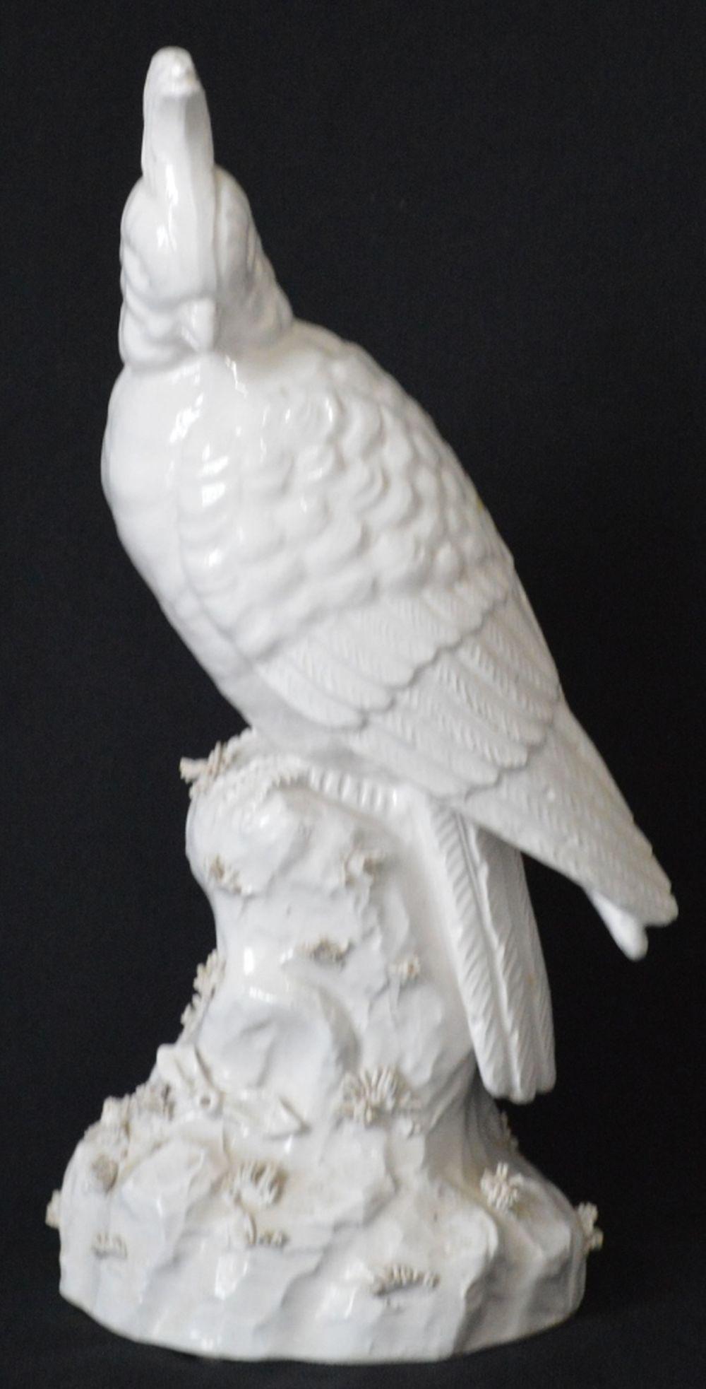 MOTTAHEDEH PORCELAIN COCKATOO: Mottahedeh design blanc de chine porcelain cockatoo Measures: H 12" x W 5 1/2" x D 5 1/2" Provenance: Property of a very well known TV/Film family.