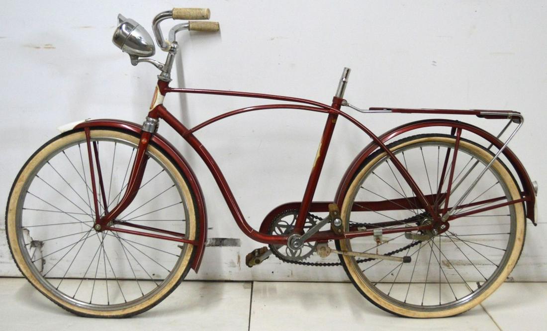 ANTIQUE RED BAUER FUTURAMIC BIKE BICYCLE: A vintage, circa 1953, Bauer Futuramic bike- made in West Germany. Appear to be original tires. Measures: H 36" x W 64" x D 20"