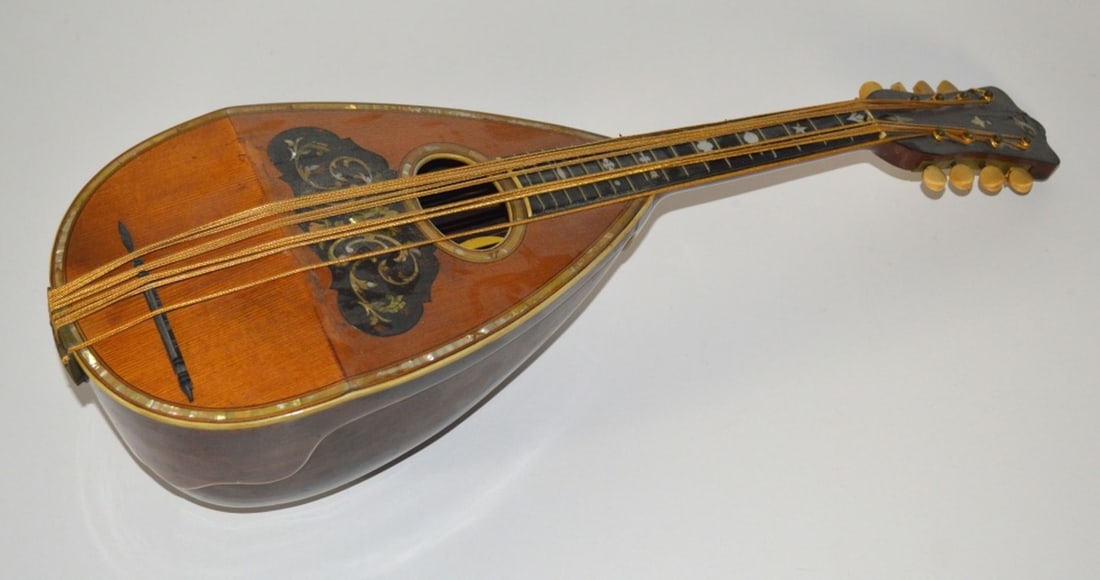 ANTIQUE VICTORIA B & J LUTE: An antique B&J Victoria lute (label attached internally). Lute is inlaid with mother of pearl and bone tuning pegs. Measures: H 24" x W 8" x D 6 1/2""