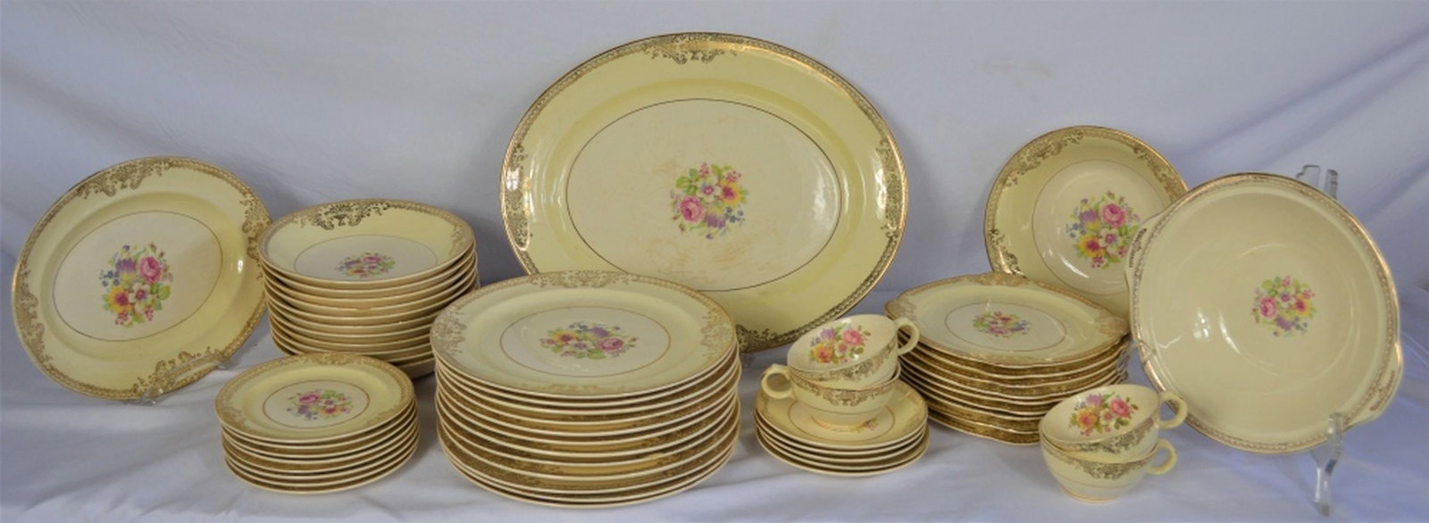 LOT 53 PCS STETSON 22K GOLD DECORATED PORCELAIN: Large lot (53 pieces) of Stetson vintage porcelain. Marked as "Warranted 22kt GOLD", verso. Platter measures: 12 1/2" x 15 3/4"