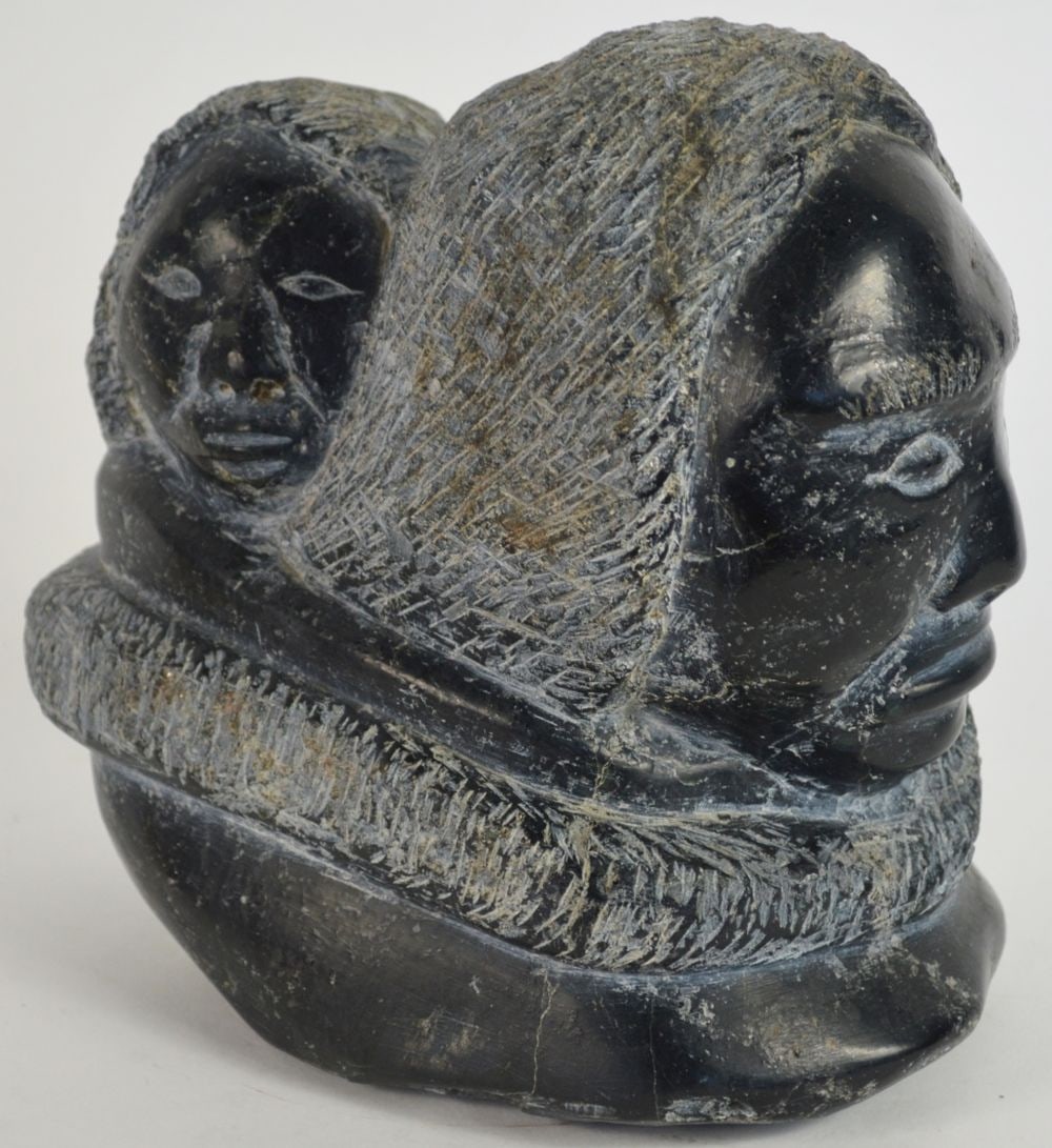 INUIT CARVED BLACK STONE SCULPTURE TRANSFORMATION: An Aboriginal Canadian / Inuit carved black stone (with traces of pyrite visible on underside) head with what appears to be a child, but might be a symbolic second head e.g. transformation figure. It 