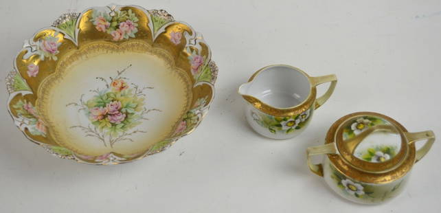 VINTAGE NIPPON FINE GILT PAINTED CHINA LOT: A lot of hand painted and gilt edged porcelain. Cream and sugar marked NIppon. The third, bowl, unmarked, possibly Limoges. Measures Largest: H 3" x Dia 10 1/4"