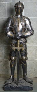 SUIT OF ARMOR FILM PROP: A suit of armor custom made for film / theatrical prop use. Mounted on a stand. Measures: H 42", W 15", D 11" Provenance: Property of a well know film/Broadway prop and costume production house.