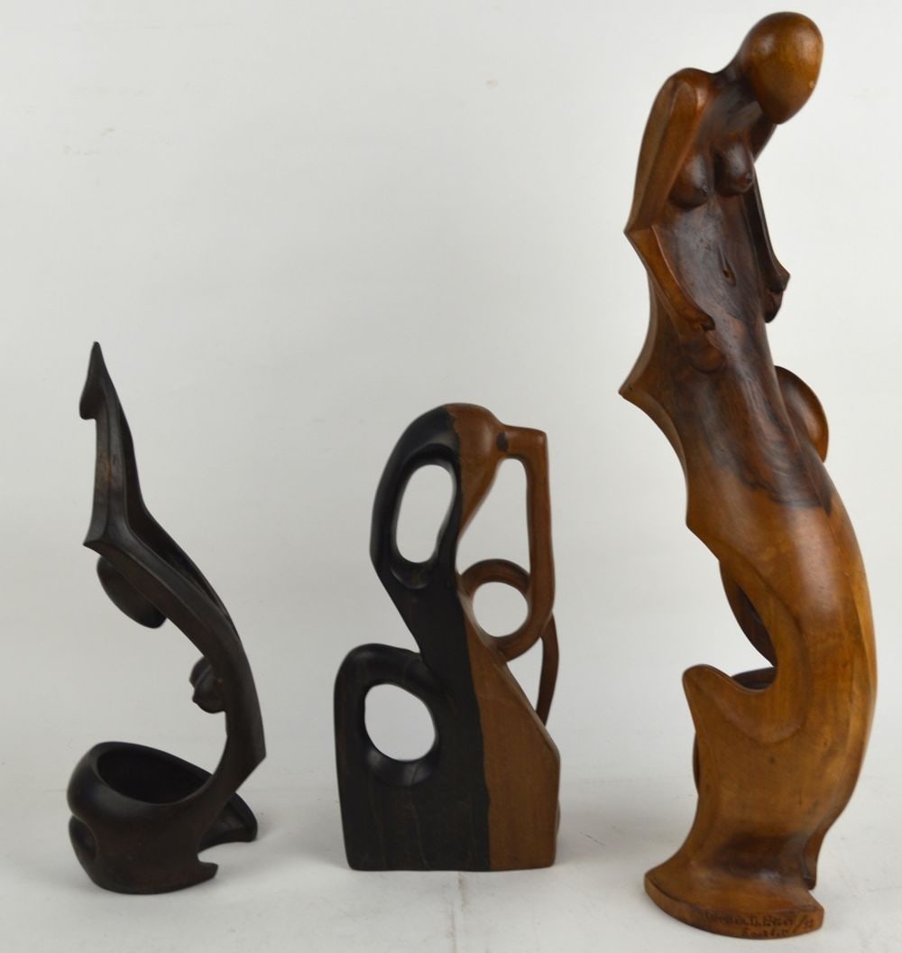 3 CARVED EROTIC ABSTRACT WOOD SCULPTURES SIGNED: A group of 3 carved wood erotic abstract sculptures. Two are signed German Potosi (Ecuador) and dated '92'. The third is not signed. Measures: Largest 21 1/2" x 6" x 6"