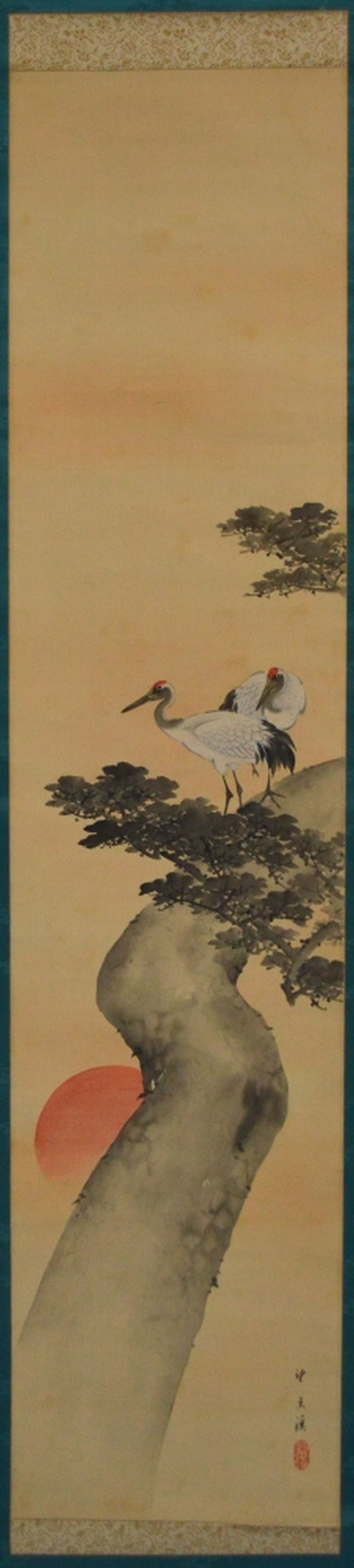 VINTAGE JAPANESE SCROLL PAINTING SIGNED: A well done vintage / antique scroll painting of cranes against a rising sun. The work is framed by fine, patterned silk, and the roll rod is of bone (missing ends). Measures: rolled 18" x 2" x 2"