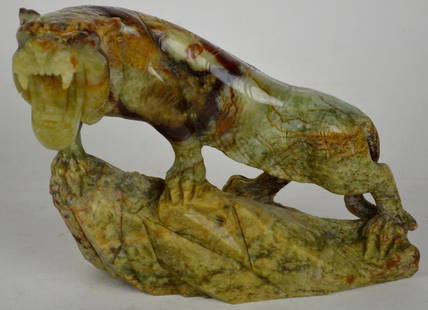 CARVED JADE NEPHRITE TIGER SCULPTURE: A carved stone (appears to be jade nephrite- not tested) sculpture of a crouching tiger. The work appears to be of Chinese origin. Measures: 8" x 10" x 7" Provenance: Property of a private