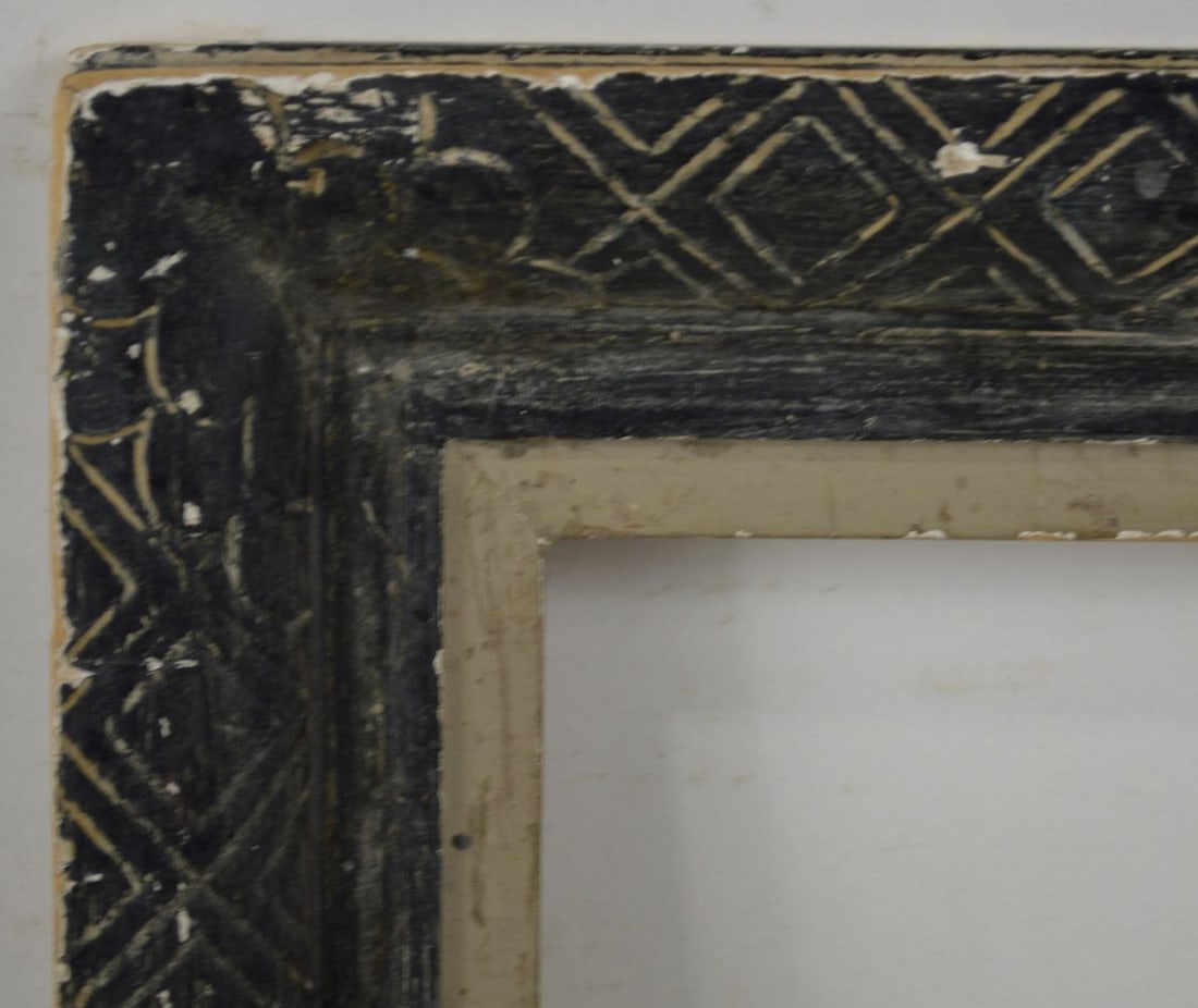 AMERICAN MODERNIST ARCHAIC DESIGN FRAME: An American modernist frame by Heydenryk with an archaic Chinese incised design (ebony to cream). Measures: 22" x 18" Rabbet: 18 14" x 14 1/4"