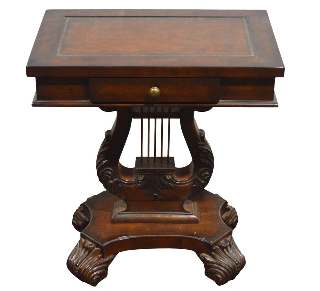 LYRE BASE LEATHER TOP TABLE W CARVED FEET: A vintage lyre base table with tooled leather insert top and carved feet. Functions as a side table with coaster pulls. Note that the table is rather solid/heavy. Measures: 30" x 26" x 16"