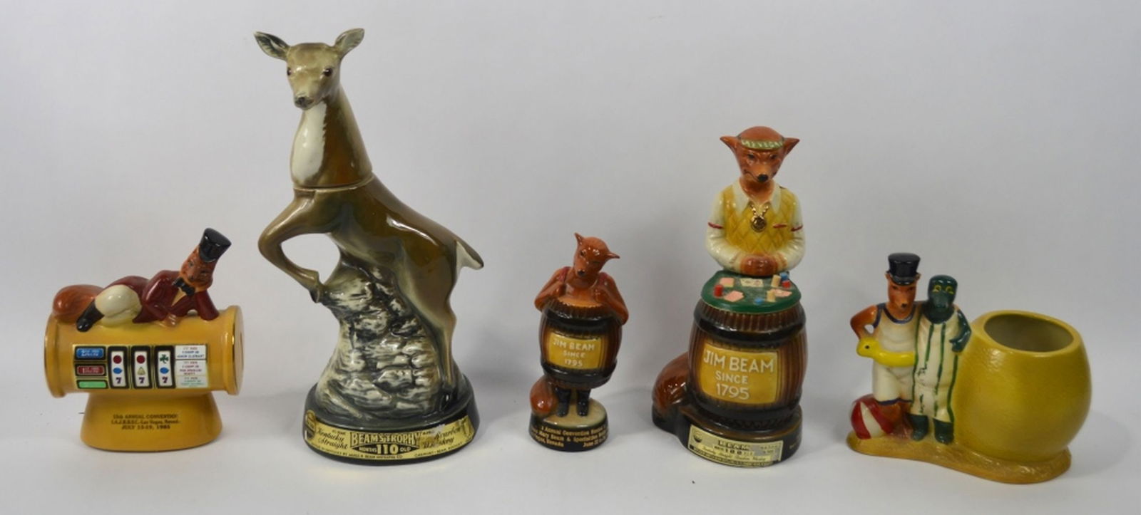 5 JIM BEAM REGAL CHINA CHARACTER BOTTLES: A group of 4 Jim Beam Regal china porcelain figures. Dated as follows: 1 x 1981 1 x 1985 2 x 1984 1 x 1967 (largest) Measures: Largest 13 3/4" x 7" x 5"