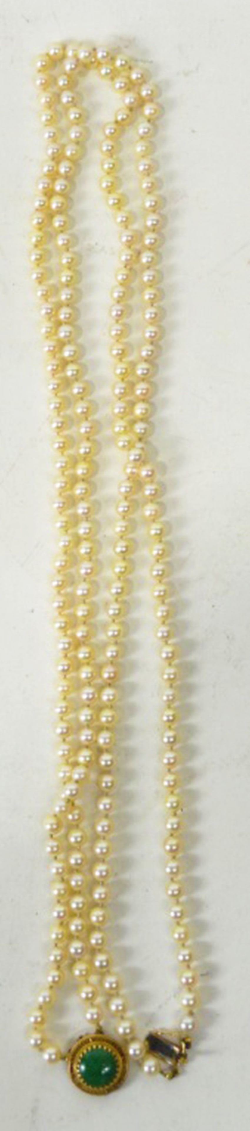 DOUBLE-STRAND PEARL NECKLACE W 14K GOLD JADE CLASP: Fine double-strand cultured pearl necklace joined with a 14K gold (tested) clasp and that is set with a round Jade Cabochon stone (app 15 mm diameter). Pearls are of very good to high quality.