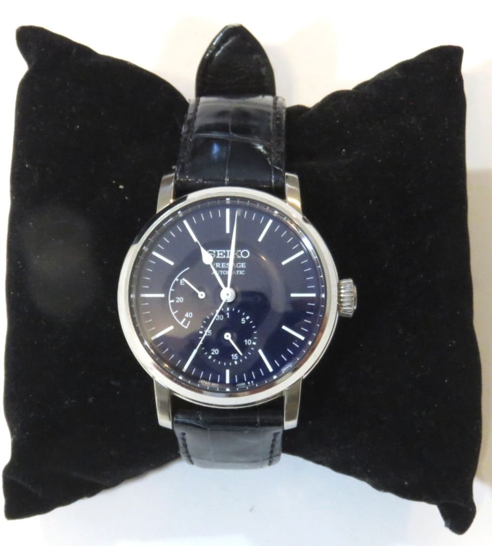 SEIKO ENAMEL DIAL AUTOMATIC POWER RESERVE WATCH: A Seiko Presage Riki Watanabe watch with date and power reserve complications and a deep blue enamel dial. The watch is powered by Seiko's in house 6R27 automatic movement. Power reserve and
