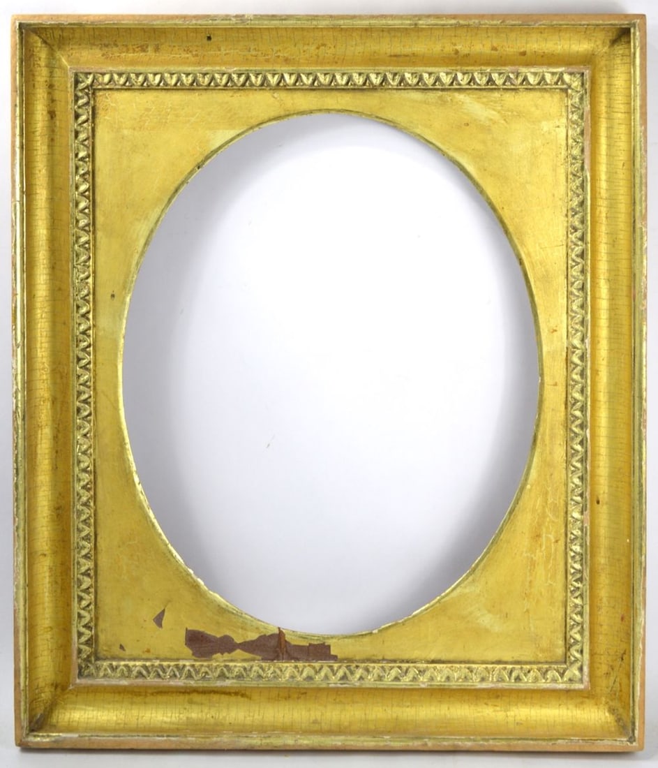 GILTWOOD SCOOP COVE PORTRAIT FRAME: A Heydenryk scoop cove lemon gold giltwood frame with an oval liner (may be/possibly removable). Lambstongue inner edge carving detail. Measures: 27 3/4" x 23 1/2" Rabbet: 22 3/4" x 18 7/8"