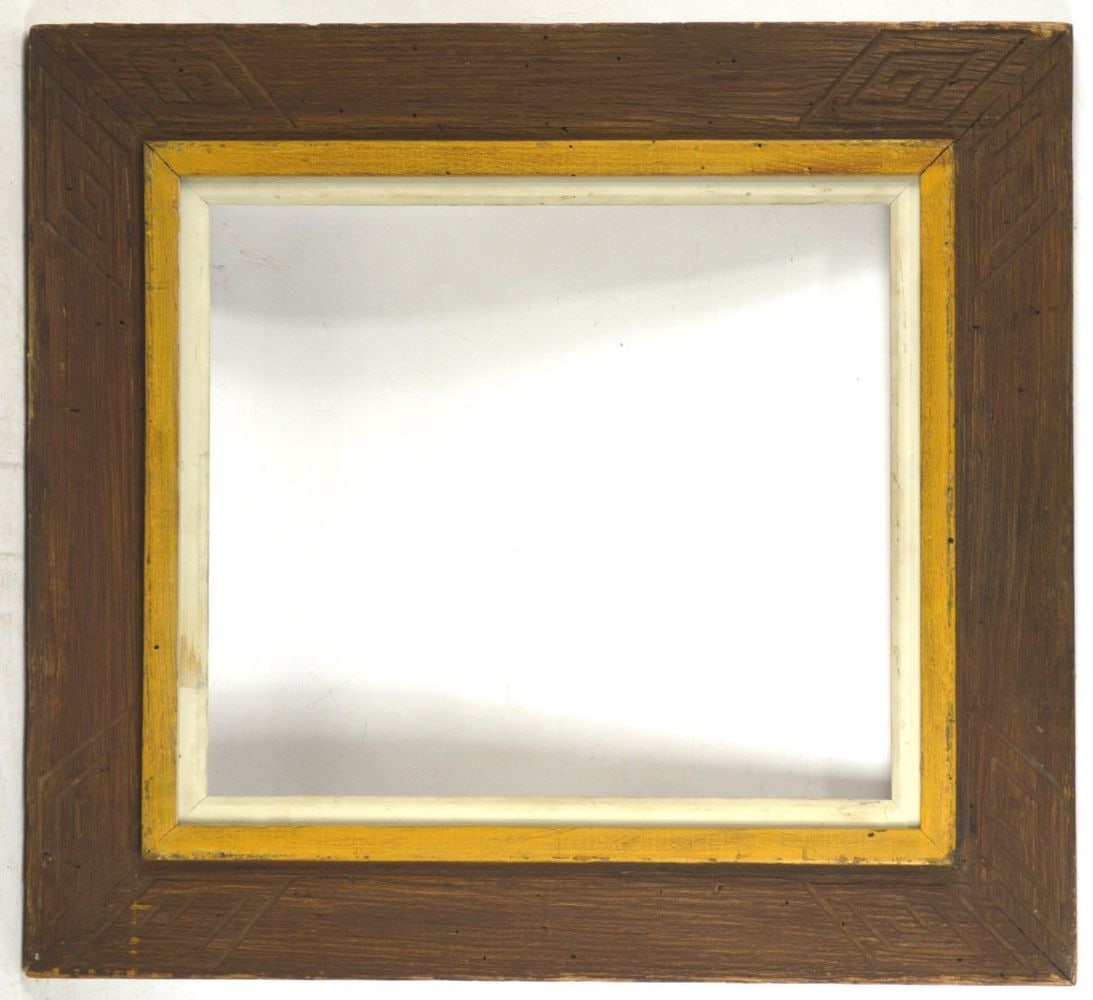 HEYDENRYK AMERICAN FOLK CARVED CHESTNUT FRAME: A finely carved American "primitive" modernist frame by Heydenryk. Slightly angled wide panel exterior presenting Native American / Aztec type carved detail and offset by a raised mustard inner boarde