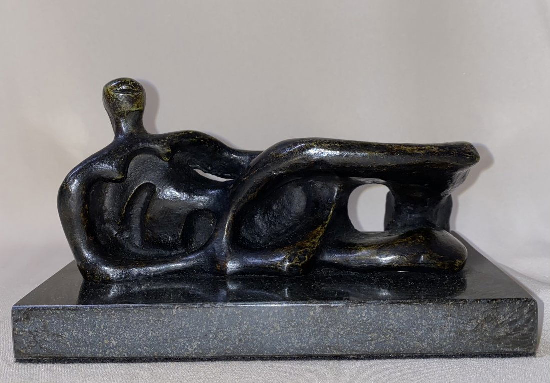 HENRY MOORE ENGLISH BRONZE SCULPTURE REGLINING FIGURE: HENRY MOORE ( 1898 -- 1986) ENGLISH BRONZE SCULPTURE SIGNED SIZE 6-1/4 x 3” Base 7 x 4 x 3/4” AFTER