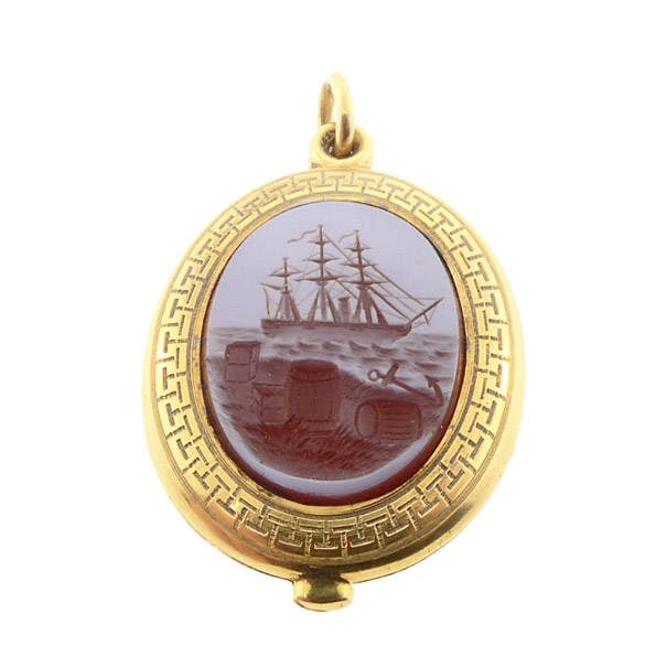 Victorian 18K Gold & Sardonyx Intaglio Ship Locket: An outstanding Victorian 18K yellow gold oval slide locket, the cover with set with an amazing sardonyx cameo depicting an early steamship also rigged with sails. The single smoke funnel, the sails