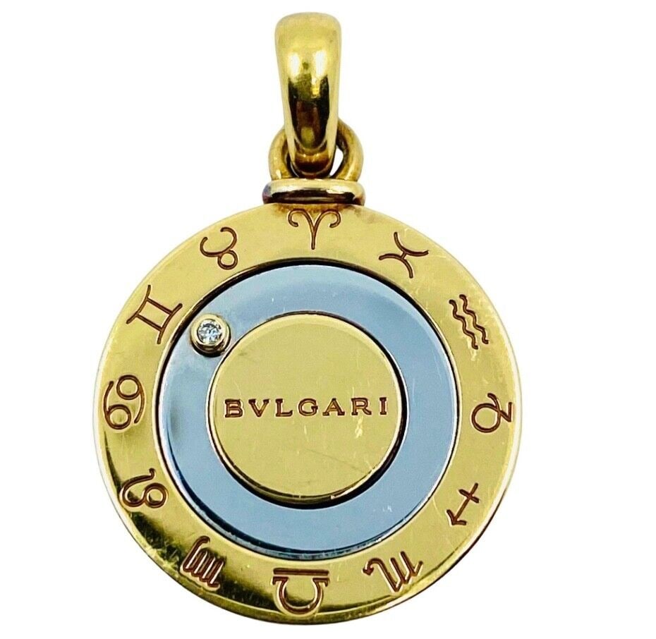 Bulgari Horoscope Movable Diamond Pendant Gold Stainless Steel: DESIGNER: Bulgari MATERIALS: 18k Gold and Stainless Steel GEMSTONE: Round Brilliant Cut Diamond WEIGHT: 10.9 grams MEASUREMENTS: Diameter - 7/8? HALLMARKS: Bvlgari, 750, Made in France, Steel a