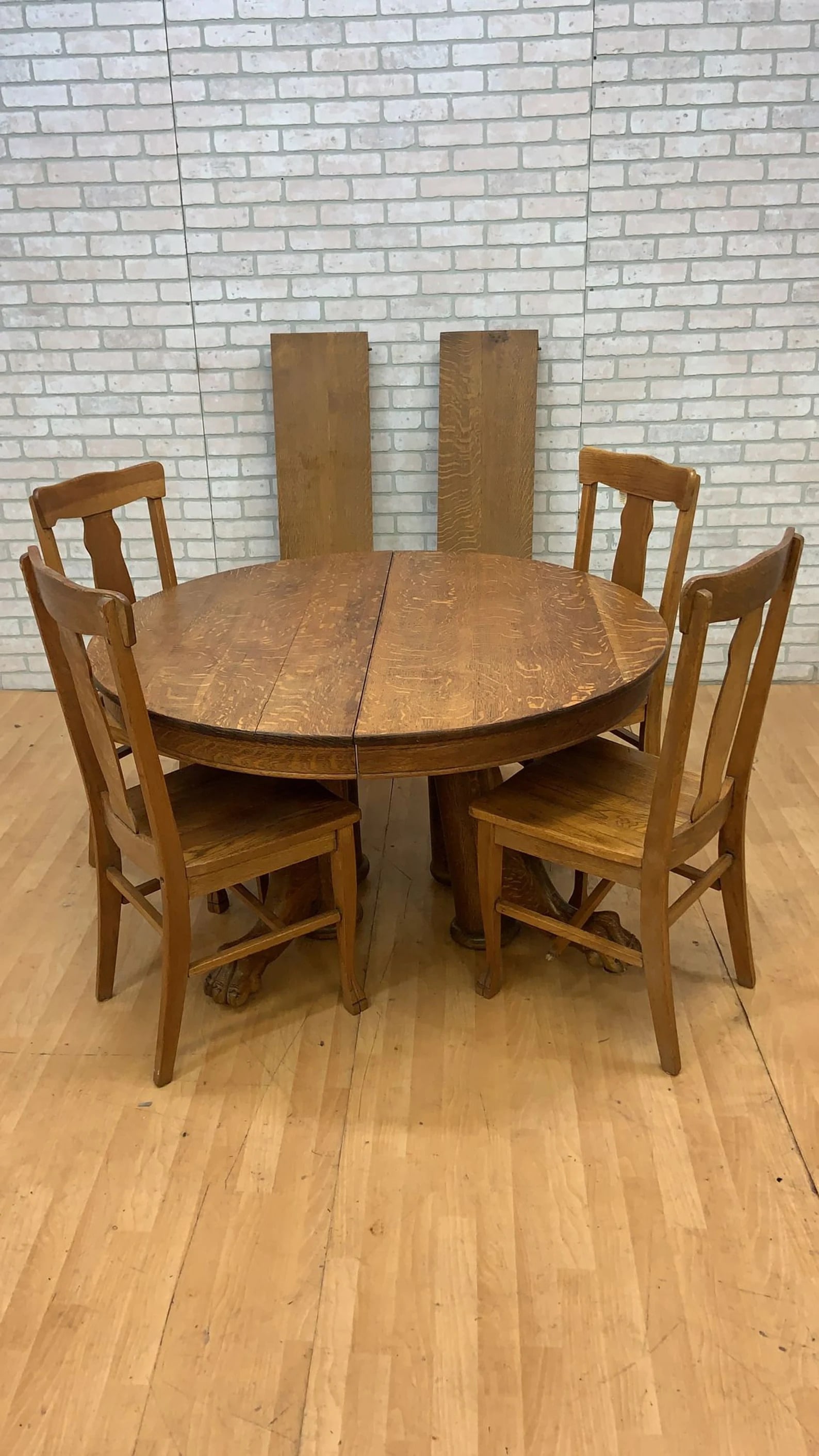 Antique 19th Century Quarter sawn oak hand carved Lyon paw foot dining/game table with 4 chairs: Antique 19th Century Quarter sawn oak hand carved Lyon paw foot dining/game table with 4 chairs. Round top pedestal dining table with 2 leaves Circa: 1890