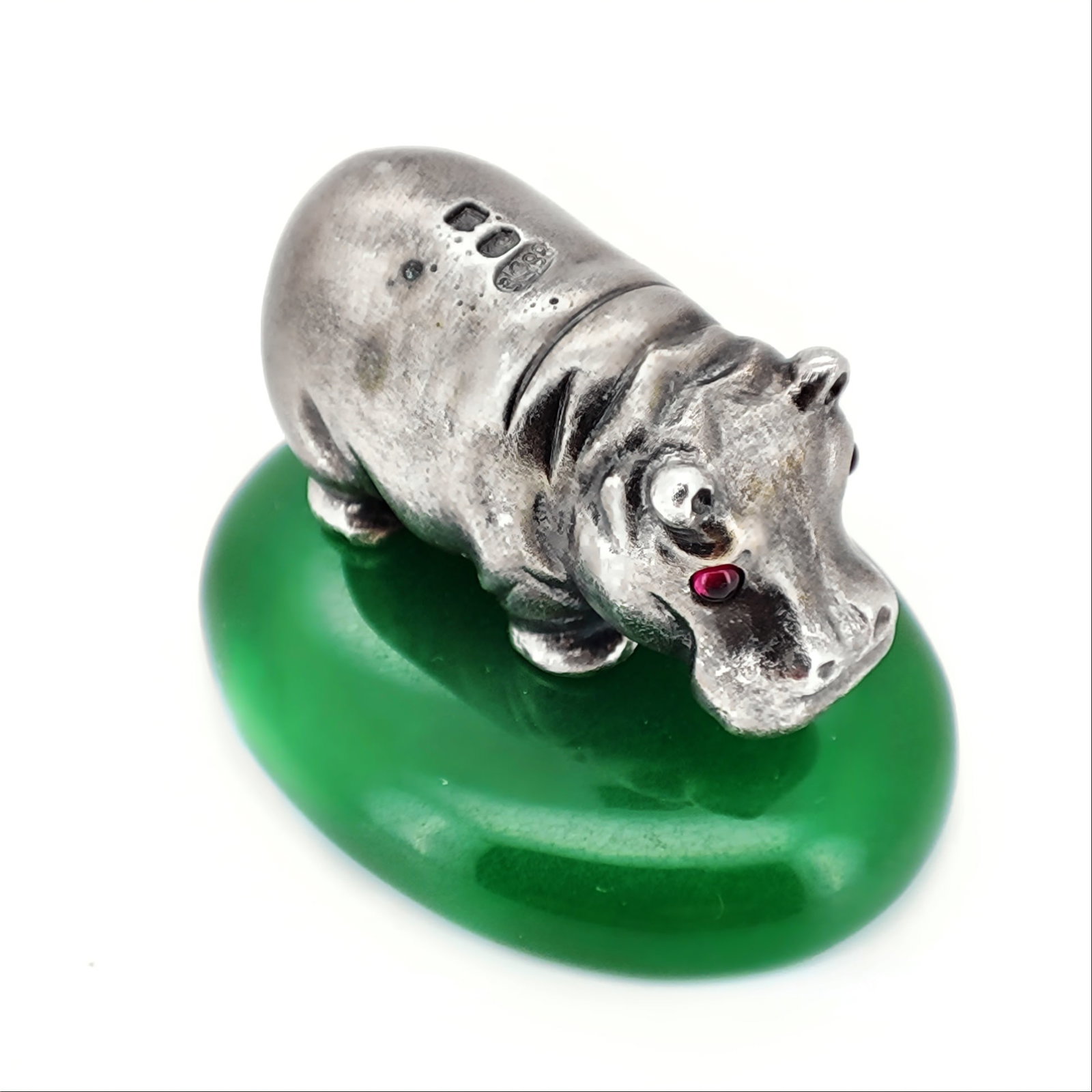 Vintage Imperial Faberge Era Silver Hippopotamus on a Nephrite: Vintage Imperial Faberge Era Silver figure of a Hippopotamus on a Nephrite stand with Garnet eyes. Total weight: 61.9 grams. Dimensions: L 40 mm. W 30 mm. H 25 mm with Nephrite stand. L 33 mm. W 14 mm