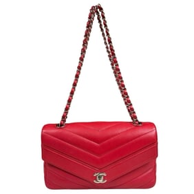 Chanel V-stitch shoulder bag in red leather with a double chain.