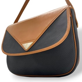 Yves Saint Laurent flap leather shoulder bag in black and brown with YSL logo plate