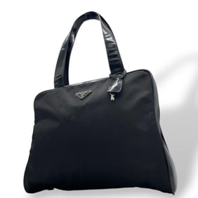Prada Tessuto handbag in nylon, leather, and enamel black with a triangular logo plate. One-shoulder