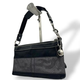 Coach handbag in black and gray with a signature one-shoulder canvas leather accents. Includes