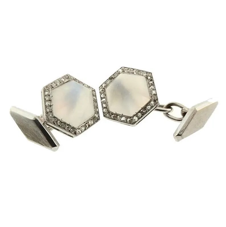 French Art Deco Platinum Moonstone & Diamond Cufflinks: A handsome pair of French Art Deco cufflinks, the faces worked in platinum centering sugarloaf cabochons of moonstone surrounded by rose cut diamonds. The moonstones have matte finish more often used