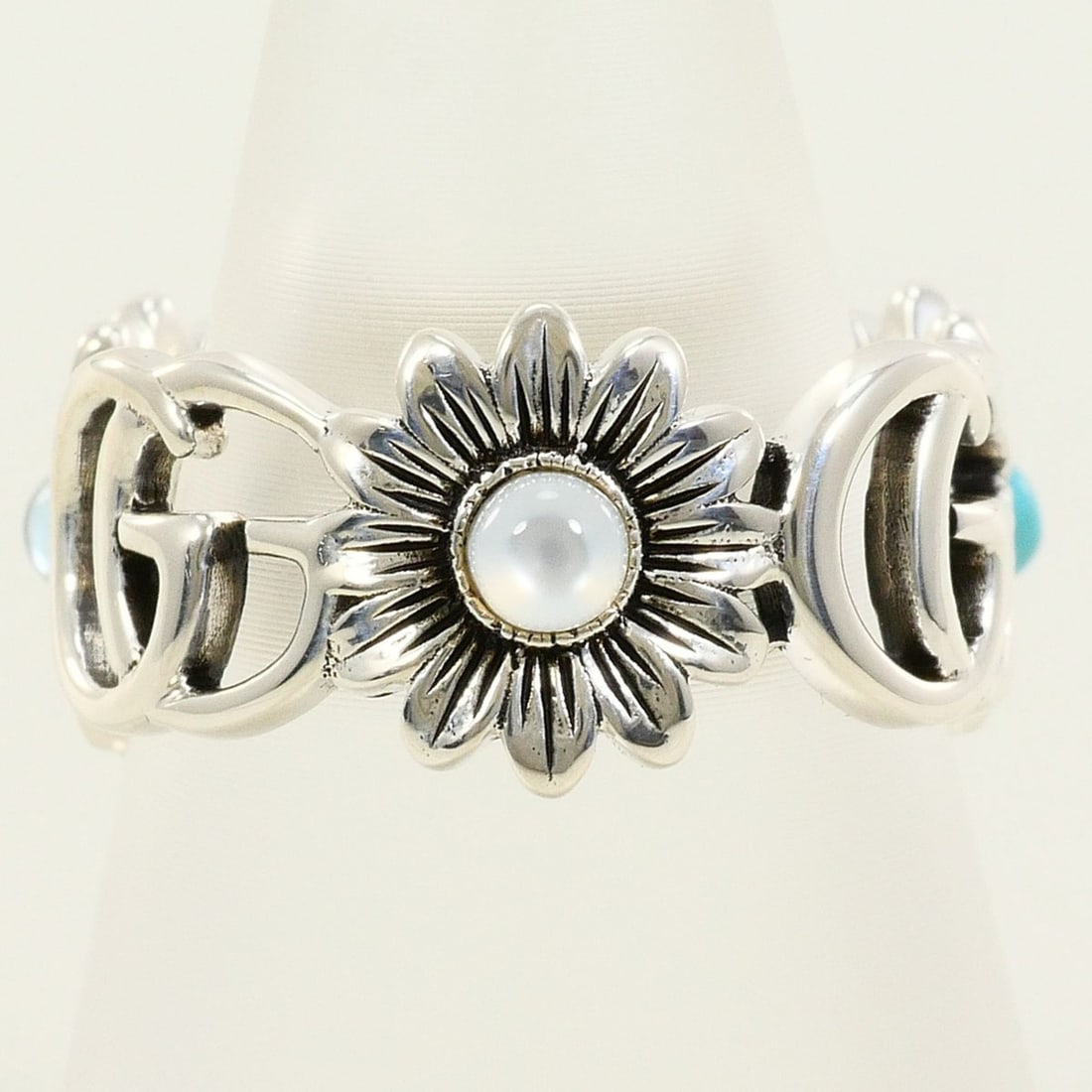 Gucci sterling silver 925 ring, size 10.5, with turquoise and blue topaz, total weight approximately: --- Catalog ---Category: SizeJP Size: 10.5US Size: 5.5Category: DesignType: Band ringColor: SilverStone: Moonstone, Topaz, TurquoiseGender: WomenMaterial: Silver 925Stone Color: Blue, WhiteCategory: G