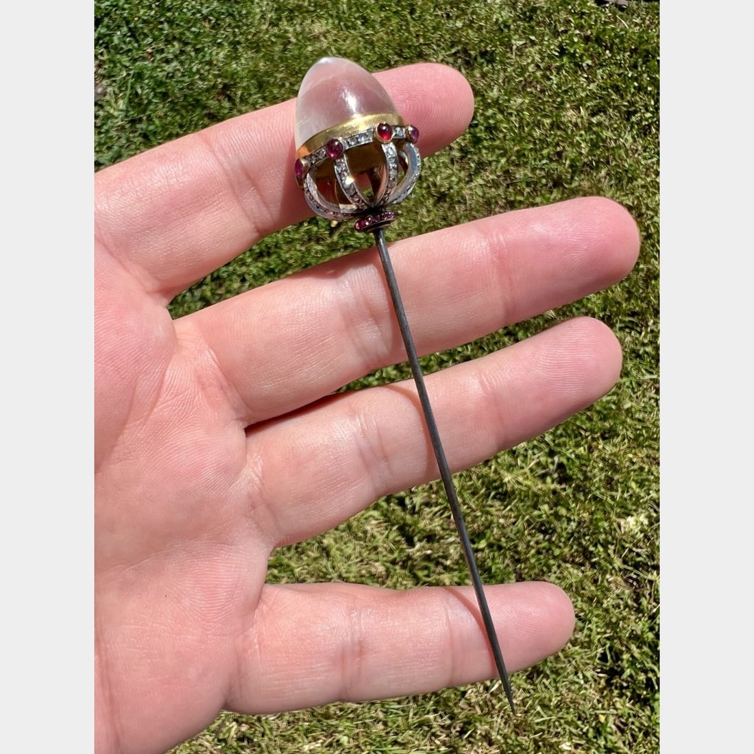 Victorian Platinum & Gold Moonstone Diamond and Ruby Pin: Victorian Platinum & Gold Moonstone Diamond and Ruby Pin?Weighing 17.9 gramsSet with a Sugarloaf Moonstone?17.6 x 16.2mmAlong with 72 Rose-cut Diamonds weighing app. 0.70 Ct.And 28 Ruby Cabochons weig