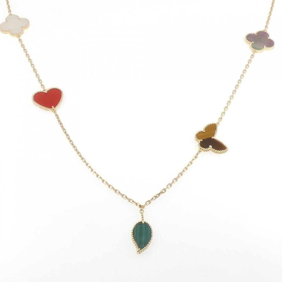 Van Cleef & Arpels Lucky Alhambra 12 motif necklace: --- Catalog ---Category: SizePendant Size: 26.8mm x 11.3mm / 1.05'' x 0.44''Neck Circumference: 89 cm / 35.03''Category: DesignColor: Yellow goldStone: Carnelian, Color stone, Malachite, Mother of pea