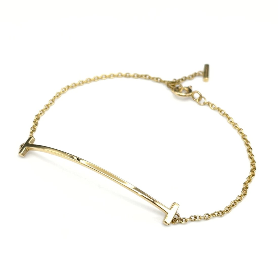 Tiffany & Co. T Smile Bracelet in Yellow Gold (750) for Women: --- Catalog ---Category: SizeLength: 17.5cm / 6.88''Category: DesignType: Charm braceletColor: YellowGender: WomenMaterial: Yellow gold (18K)Category: GeneralBrand: Tiffany--- Item List ---Section: Co