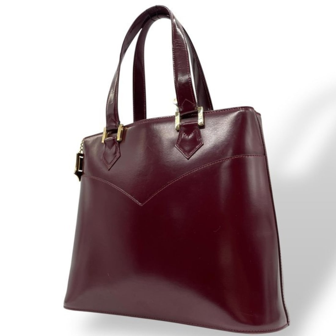 Yves Saint Laurent handbag in patent leather, Bordeaux, gold hardware, and enamel. Women's size E.: --- Catalog ---Category: SizeSize (HxWxD): 25cm x 31cm x 11cm / 9.84'' x 12.2'' x 4.33''Category: DesignType: HandbagColor: BordeauxStyle: True vintageGender: WomenMaterial: Patent leather Category: G