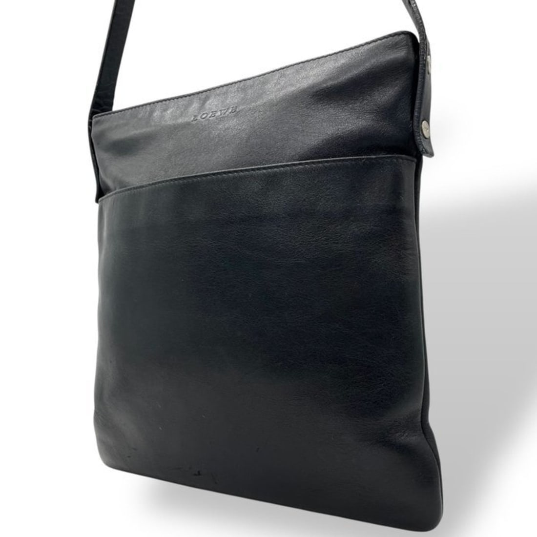 LOEWE Minimalist Crossbody Shoulder Bag C7 in Smooth Leather, Black with Silver Hardware: --- Catalog ---Category: SizeSize (HxWxD): 26cm x 25cm x 7cm / 10.23'' x 9.84'' x 2.75''Category: DesignType: Shoulder bagColor: BlackGender: WomenMaterial: Leather Category: GeneralBrand: Loewe--- It