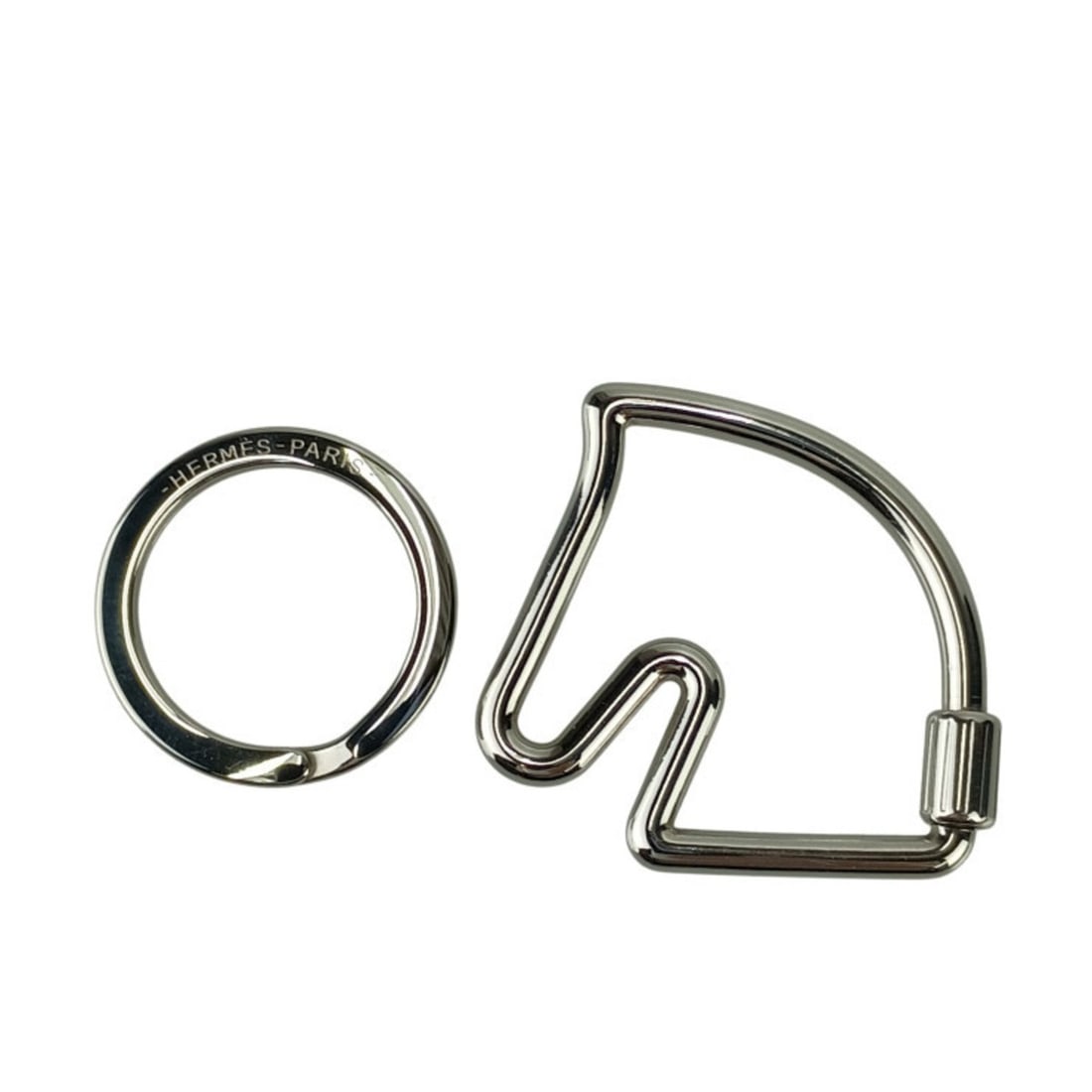 HERMES Cheval Silver Metal Keychain with Horse Motif for Men and Women: --- Catalog ---Category: SizeSize (HxWxD): 4.5cm x 4.7cm / 1.77'' x 1.85''Category: DesignType: KeyringStyle: FashionGender: Men,Women,UnisexMaterial: MetalCategory: GeneralBrand: HermesCountry of Ori