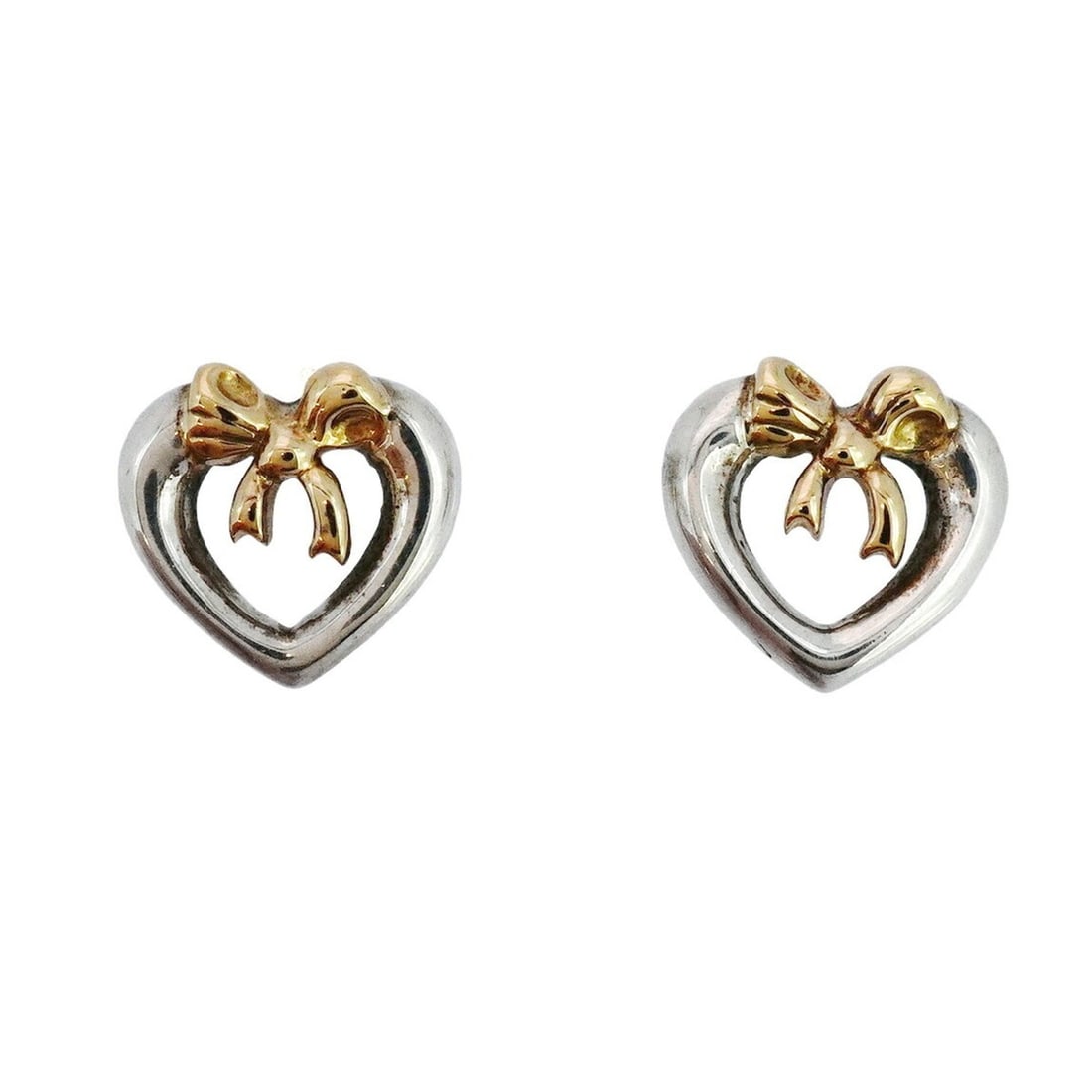 Tiffany Ribbon Heart Earrings in 18K Yellow Gold and 925 Sterling Silver for Women: --- Catalog ---Category: SizeSize (HxWxD): 10.90mm x 11.70mm / 0.43'' x 0.46''Category: DesignType: Stud earringsGender: WomenMaterial: Silver 925, Yellow gold (18K)Category: GeneralBrand: Tiffany---
