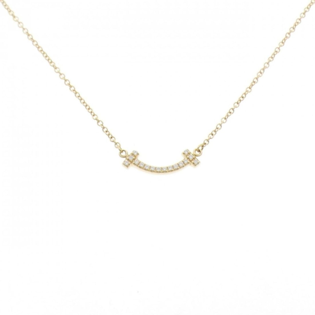 Tiffany T Smile Mini Necklace: --- Catalog ---Category: SizePendant Size: 4.2mm x 13.5mm / 0.16'' x 0.53''Neck Circumference: 41 cm - 46 cm / 16.14'' - 18.11''Category: DesignStone: DiamondGender: WomenMaterial: Yellow gold