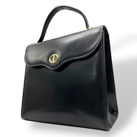 Christian Dior top handle handbag in black leather with gold hardware.