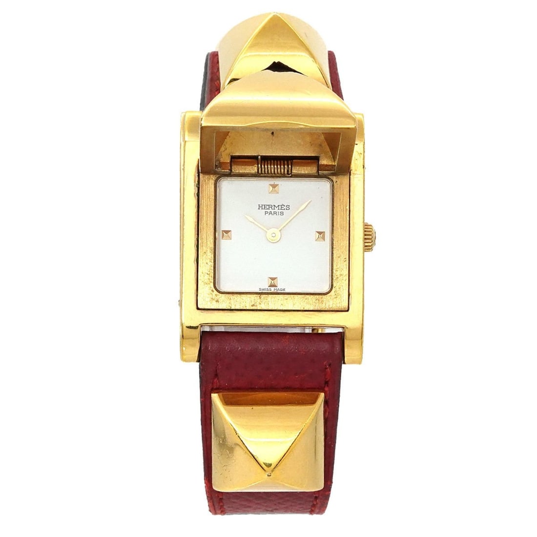 Hermès Medor Women's Pyramid Gold Stud Watch in White and Red Leather with Quartz Movement: --- Catalog ---Category: SizeWrist Size: 14cm - 16.5cm / 5.51'' - 6.49''Case Diameter: 23mm / 0.91''Category: DesignType: WristwatchGender: WomenColor (Dial): WhiteMaterial (Band): Gold plated, Leathe